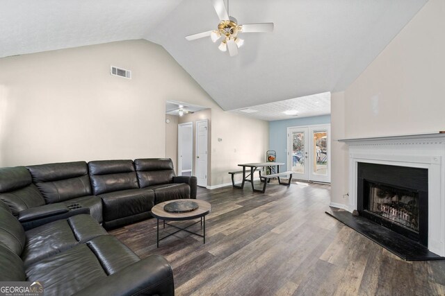 living room featuring a textured ceiling, french doors, hardwood / wood-style floors, lofted ceiling, and ceiling fan