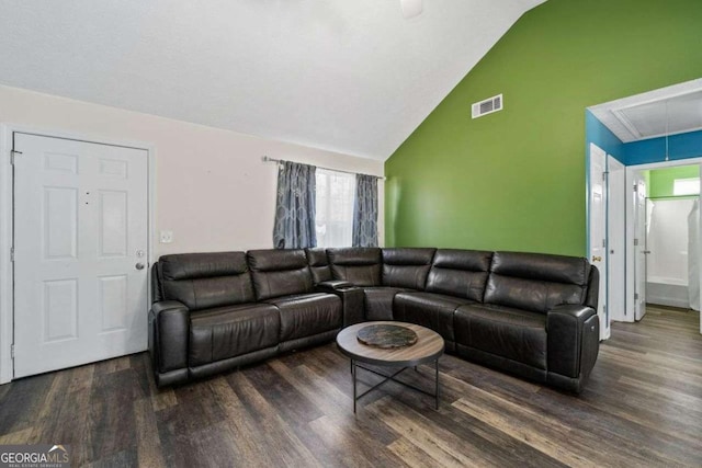 living room featuring lofted ceiling and dark hardwood / wood-style flooring