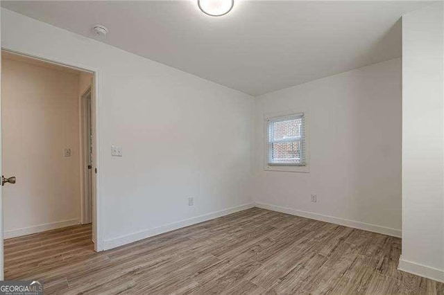 empty room with light hardwood / wood-style flooring