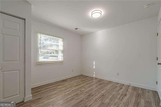 spare room featuring light hardwood / wood-style flooring