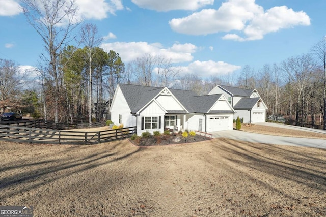 new england style home featuring a front yard and a garage