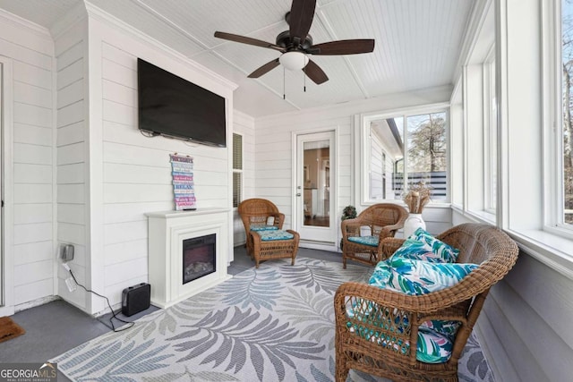 sunroom / solarium featuring ceiling fan