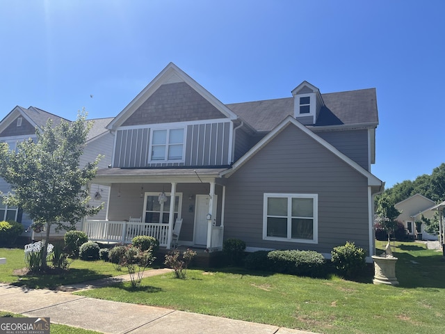 view of front of house with a front lawn and a porch