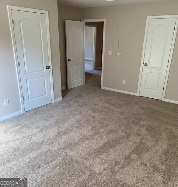 unfurnished bedroom with light colored carpet