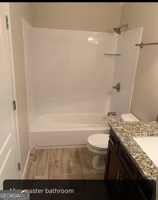 full bathroom with toilet, bathing tub / shower combination, and vanity