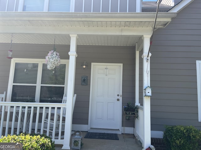 view of exterior entry with a porch