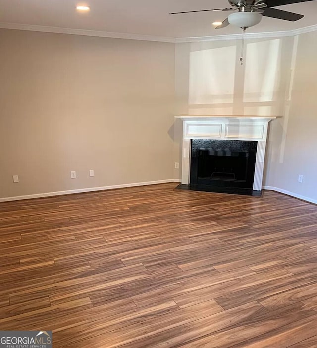 unfurnished living room featuring hardwood / wood-style flooring and crown molding