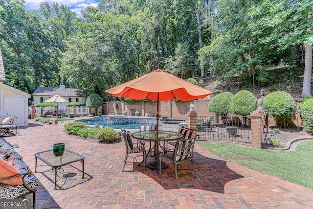 view of patio / terrace featuring a fenced in pool and a storage unit