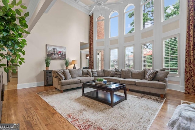 living room with a high ceiling and light wood-type flooring