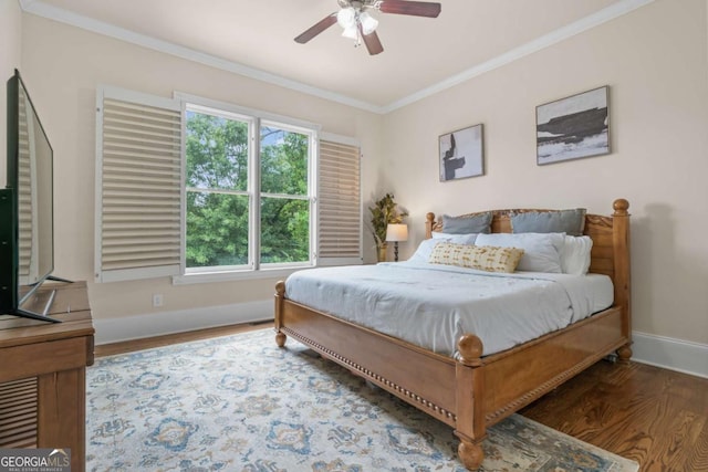 bedroom featuring dark hardwood / wood-style flooring, crown molding, and ceiling fan