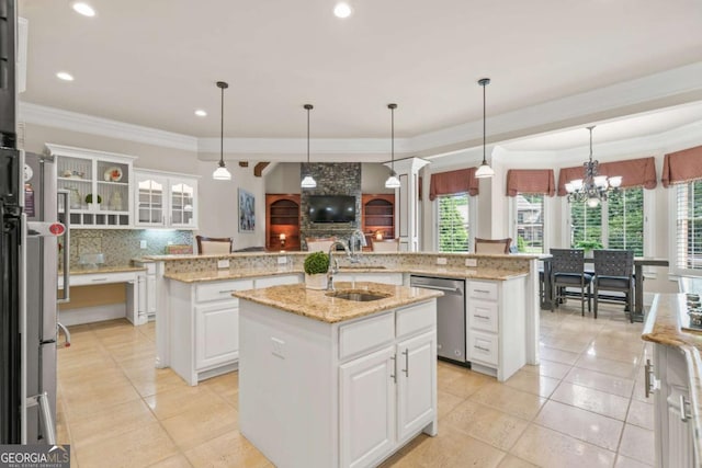 kitchen with white cabinetry, sink, stainless steel appliances, and a center island with sink