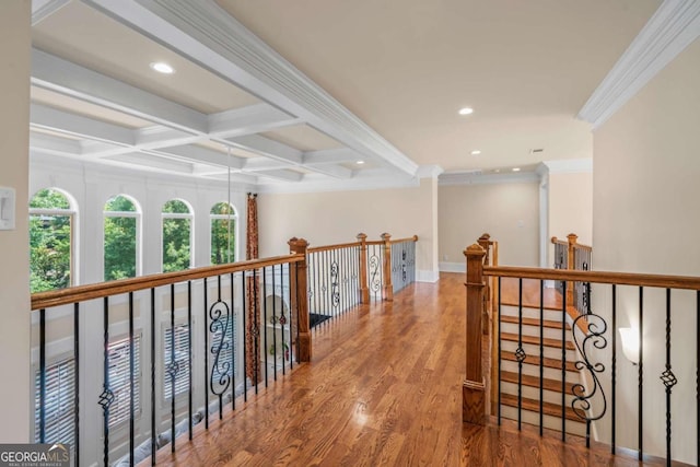 corridor with ornamental molding, coffered ceiling, wood-type flooring, and beam ceiling