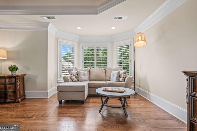 living room with hardwood / wood-style flooring and ornamental molding