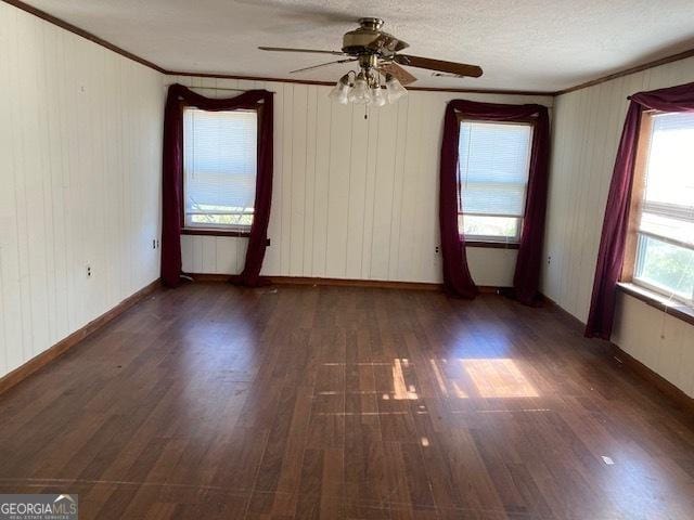 spare room with a textured ceiling, radiator, ceiling fan, dark hardwood / wood-style flooring, and ornamental molding