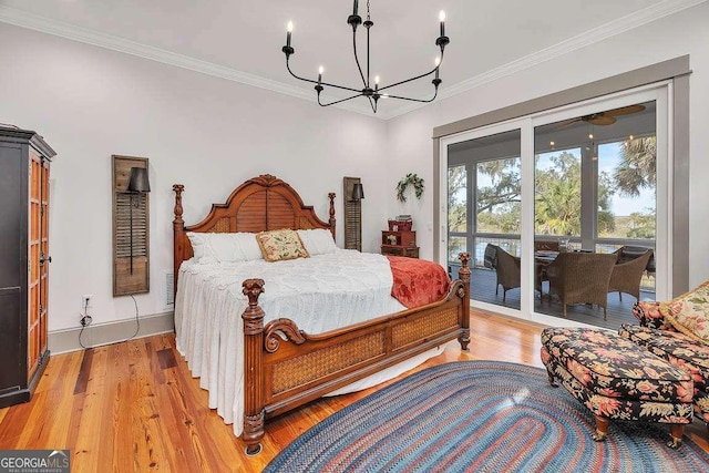 bedroom featuring crown molding, access to outside, an inviting chandelier, and light hardwood / wood-style flooring