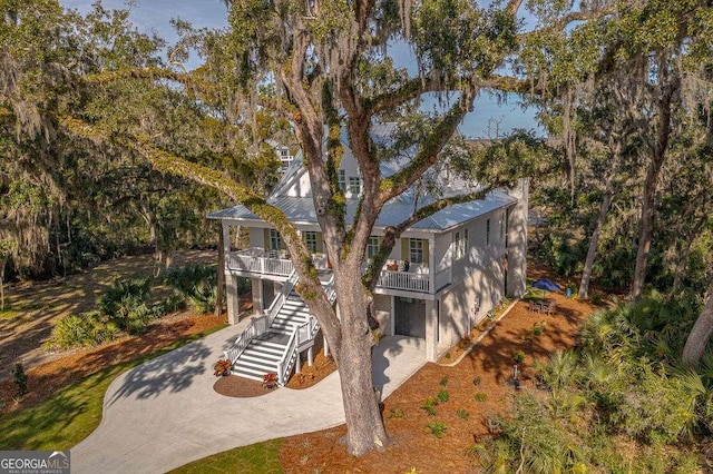 exterior space featuring a balcony, a garage, and a porch