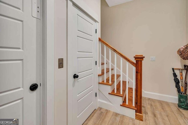 staircase with wood-type flooring