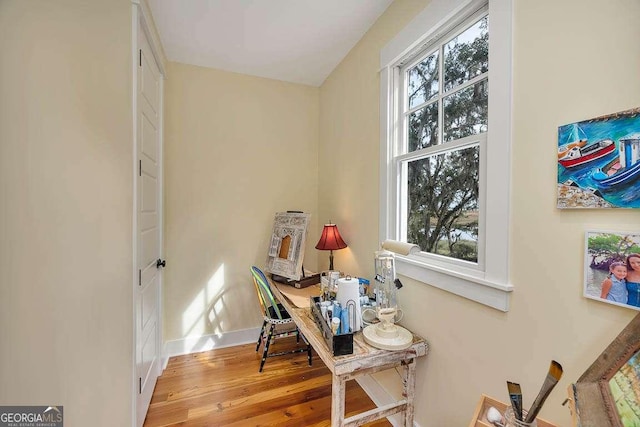 home office with light hardwood / wood-style flooring