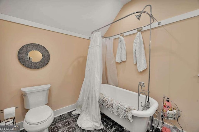 bathroom featuring lofted ceiling and toilet