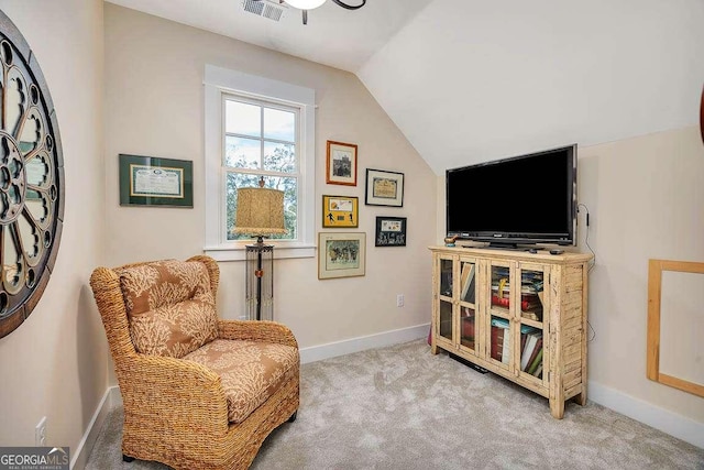 living area featuring carpet floors and vaulted ceiling