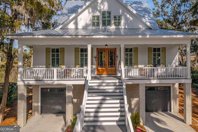 view of front facade with french doors, a garage, and covered porch