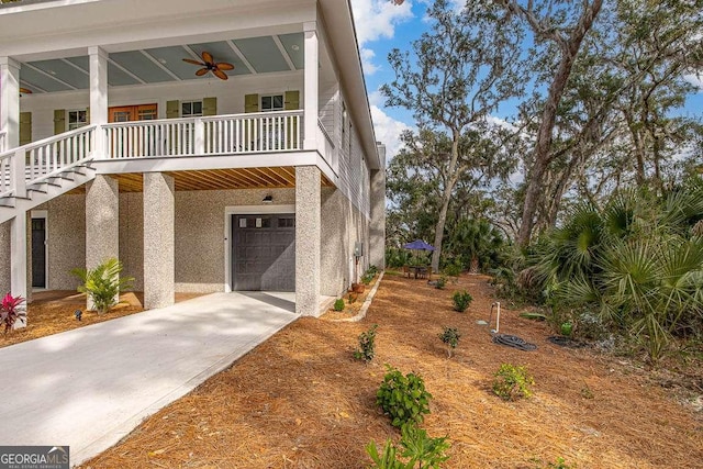 view of front of home with a garage and ceiling fan