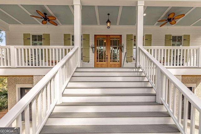 entrance to property featuring covered porch, ceiling fan, and french doors