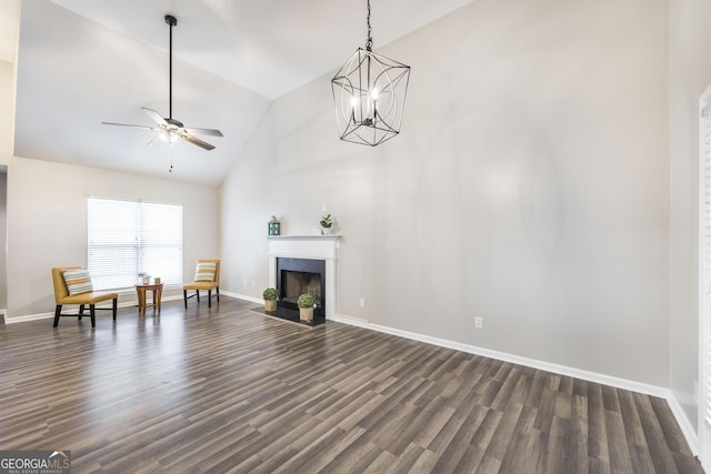 unfurnished room featuring ceiling fan with notable chandelier, lofted ceiling, and dark hardwood / wood-style floors