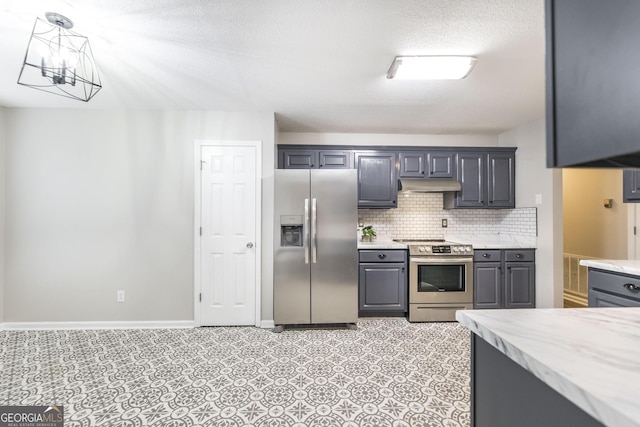 kitchen with pendant lighting, stainless steel appliances, a notable chandelier, decorative backsplash, and gray cabinetry