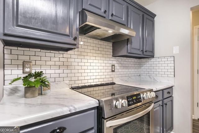 kitchen with stainless steel electric stove, tasteful backsplash, and light stone counters