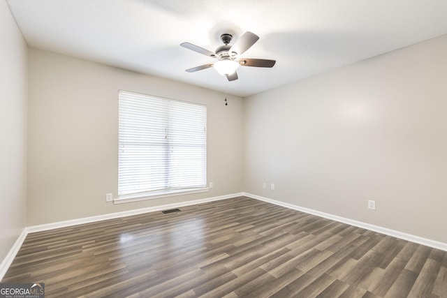 unfurnished room featuring ceiling fan and dark hardwood / wood-style floors