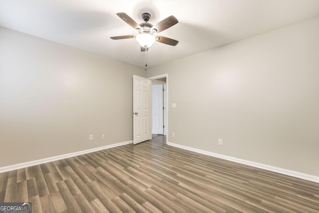 empty room featuring ceiling fan and dark hardwood / wood-style floors