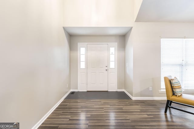 foyer with dark hardwood / wood-style floors