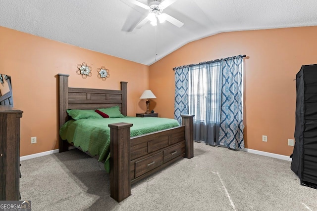 carpeted bedroom featuring ceiling fan, a textured ceiling, and vaulted ceiling