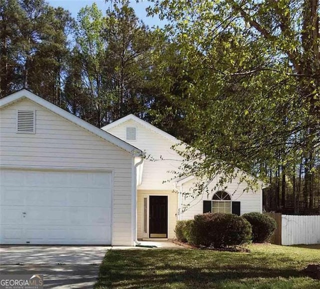 view of front facade featuring a front lawn and a garage