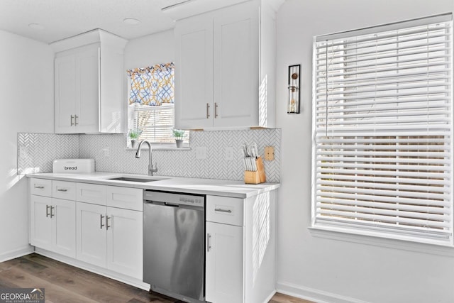 kitchen featuring white cabinets, dark hardwood / wood-style flooring, decorative backsplash, sink, and stainless steel dishwasher