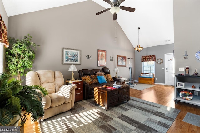 living room featuring ceiling fan, hardwood / wood-style floors, and high vaulted ceiling