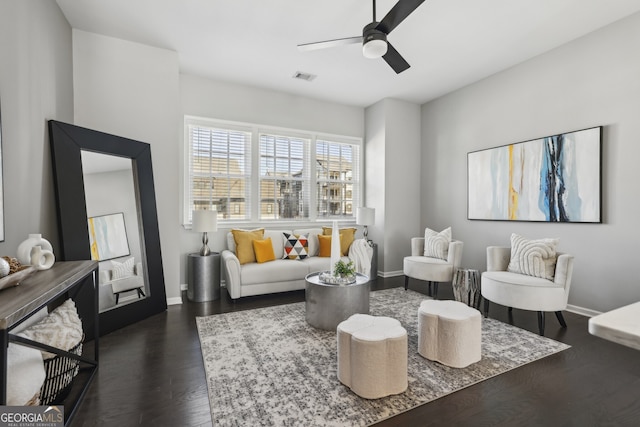 living room featuring ceiling fan and dark hardwood / wood-style flooring