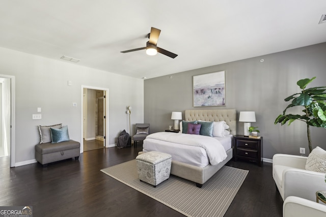 bedroom featuring connected bathroom, ceiling fan, and dark hardwood / wood-style floors