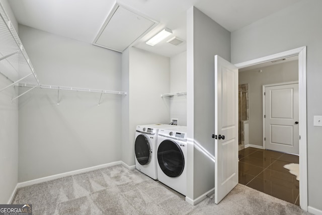 laundry room with light colored carpet and washer and clothes dryer