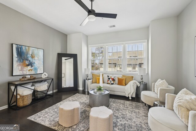 living room with ceiling fan and dark hardwood / wood-style flooring