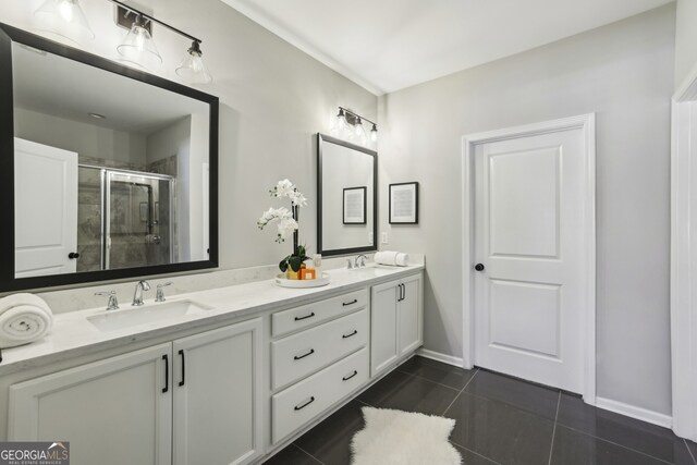 bathroom with vanity, a shower with door, and tile patterned flooring