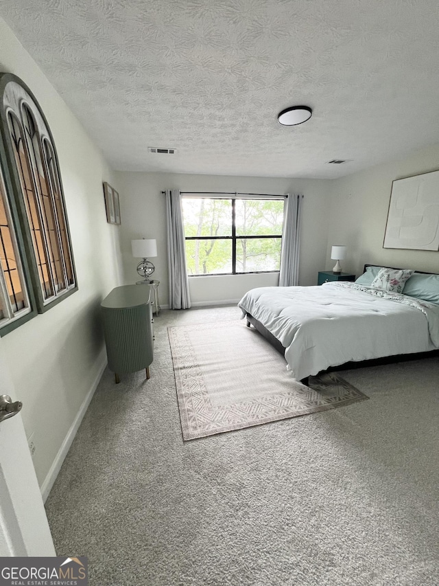 148 N Stewart Ln, Griffin, GA 30224 - bedroom featuring baseboards, visible vents, carpet floors, and a textured ceiling