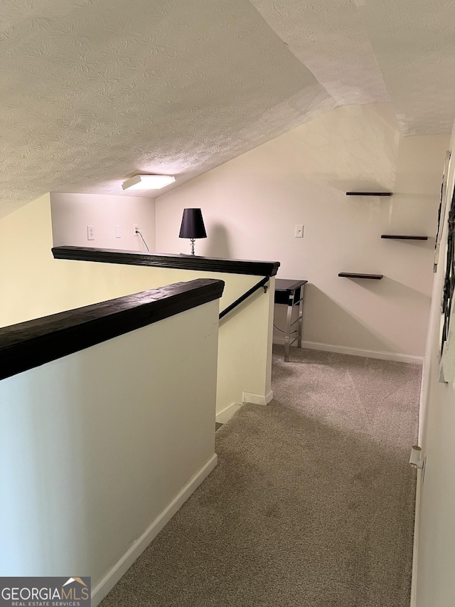148 N Stewart Ln, Griffin, GA 30224 - hall with a textured ceiling, lofted ceiling, carpet floors, and baseboards
