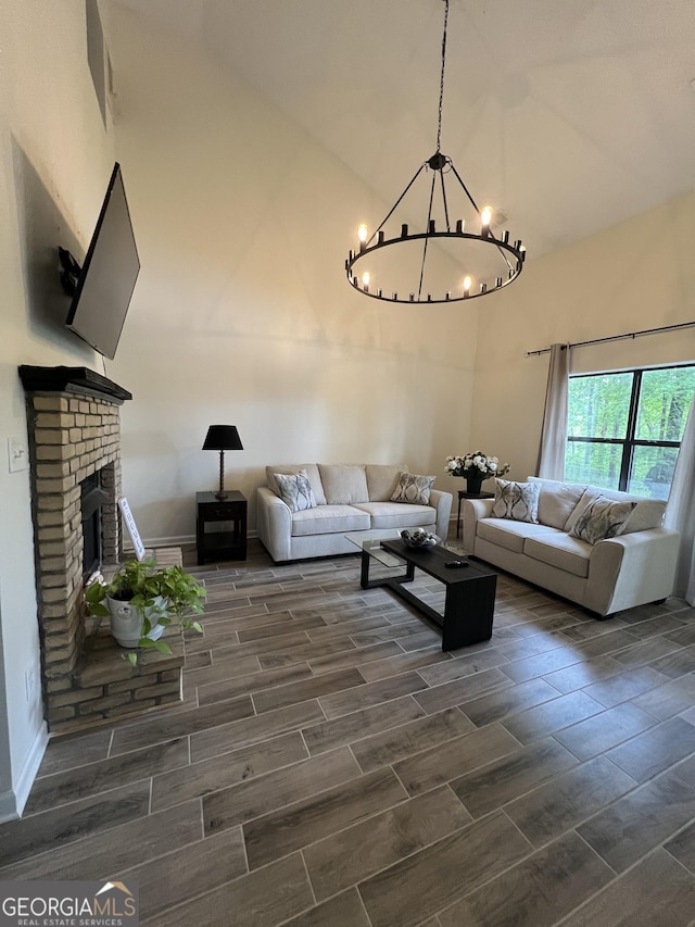 148 N Stewart Ln, Griffin, GA 30224 - living area featuring an inviting chandelier, a fireplace, wood tiled floor, high vaulted ceiling, and baseboards