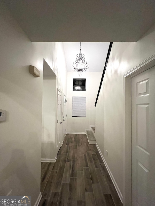 148 N Stewart Ln, Griffin, GA 30224 - hall featuring baseboards, a notable chandelier, and dark wood-style flooring
