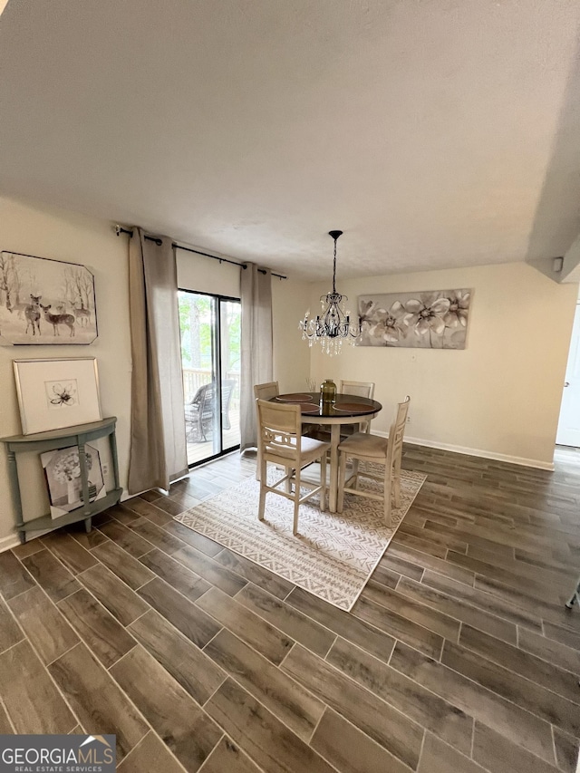 148 N Stewart Ln, Griffin, GA 30224 - dining space featuring an inviting chandelier, dark wood-style flooring, and baseboards