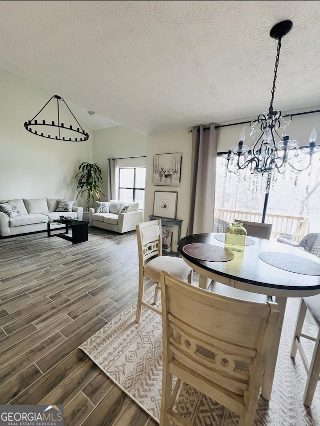 148 N Stewart Ln, Griffin, GA 30224 - dining area with wood finished floors, a notable chandelier, and a textured ceiling