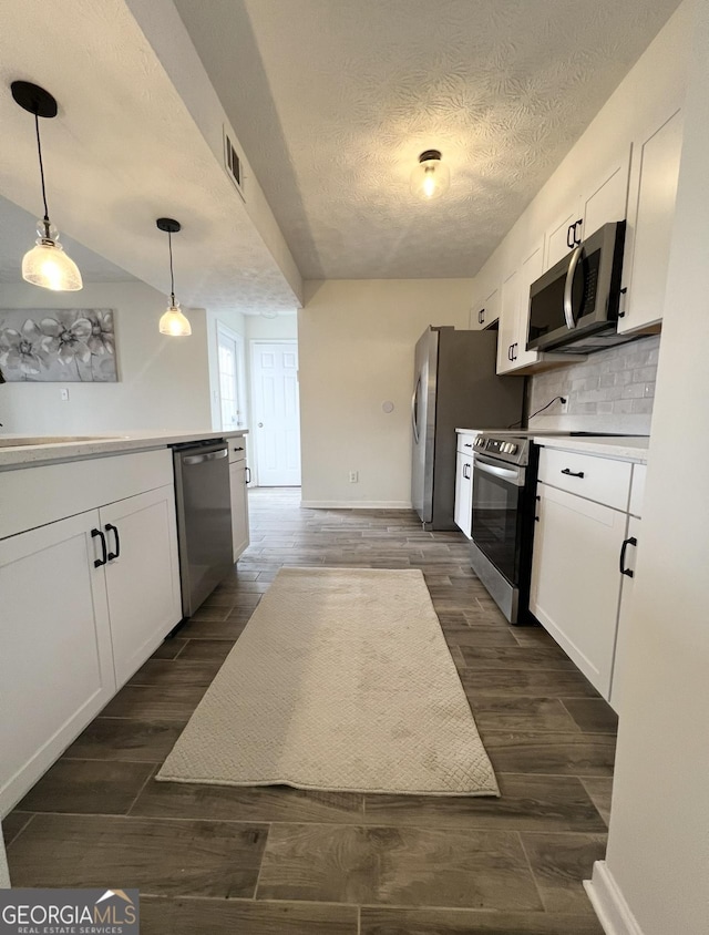 148 N Stewart Ln, Griffin, GA 30224 - kitchen featuring white cabinetry, visible vents, stainless steel appliances, and a textured ceiling