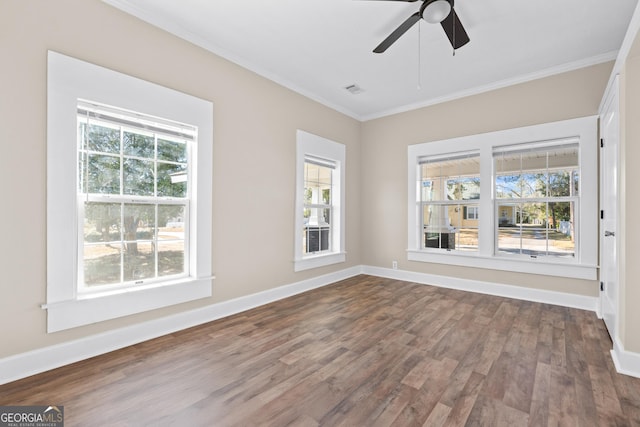 empty room with ceiling fan, hardwood / wood-style flooring, and crown molding